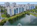 Aerial view of waterfront community with lush landscaping and a pond at 5300 S Atlantic Ave # 15-403, New Smyrna Beach, FL 32169