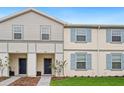 Two-story townhome with light gray and beige siding at 3982 Lana Ave, Davenport, FL 33897