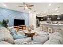 Open living room and kitchen with blue accent wall at 3982 Lana Ave, Davenport, FL 33897