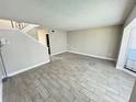 Bright and airy living room with gray tile flooring and a staircase at 6003 Village Cir # Ge, Orlando, FL 32822