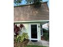 Townhouse with a brown shingled roof and a black front door at 6003 Village Cir # Ge, Orlando, FL 32822