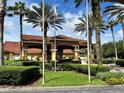 Encantada clubhouse entrance with landscaping at 3056 Yellow Lantana Ln, Kissimmee, FL 34747