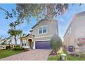 Two-story house with a two-car garage and palm trees at 1586 Lima Ave, Kissimmee, FL 34747