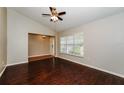 Bright living room featuring dark hardwood floors and a ceiling fan at 3229 Clewiston St, Deltona, FL 32738