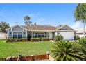 Charming one-story home with a well-maintained lawn and attached garage at 3229 Clewiston St, Deltona, FL 32738