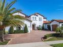 Two-story home with tile roof, solar panels and brick driveway at 15680 Panther Lake Dr, Winter Garden, FL 34787