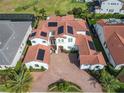 Two-story home with tile roof, solar panels and brick driveway at 15680 Panther Lake Dr, Winter Garden, FL 34787