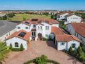 Two-story home with tile roof, solar panels and brick driveway at 15680 Panther Lake Dr, Winter Garden, FL 34787
