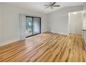 Spacious living room with light wood flooring and sliding glass doors at 232 Riverbend Dr # 201, Altamonte Springs, FL 32714