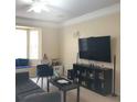 Living room with large TV and seating area at 6682 Time Square Ave # 101, Orlando, FL 32835