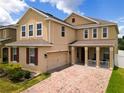 Two-story house with a brick driveway and red shutters at 1508 Caterpillar St, St Cloud, FL 34771
