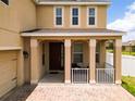 Covered front porch with columns and a brick walkway at 1508 Caterpillar St, St Cloud, FL 34771