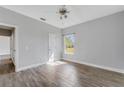 Spacious bedroom with wood-look tile floors and large window at 2017 W State Road 426, Oviedo, FL 32765