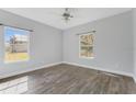 Bright bedroom with wood-look tile flooring and ceiling fan at 2017 W State Road 426, Oviedo, FL 32765