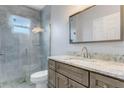 Updated bathroom with gray cabinets and a large shower at 2017 W State Road 426, Oviedo, FL 32765