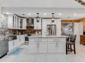 Modern kitchen with white cabinets, stainless steel appliances, and an island at 11154 Park Ave, Windermere, FL 34786