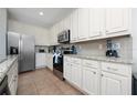 Bright kitchen with white cabinets and granite counters at 2588 Shanti Dr, Kissimmee, FL 34746
