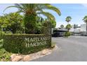 Maitland Harbour entrance sign with lush green hedge at 1000 S Orlando Ave # A5, Maitland, FL 32751