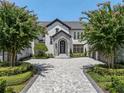 Grand entrance of a stunning home with a brick paved driveway at 9832 Laurel Valley Dr, Windermere, FL 34786