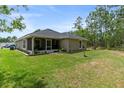 House with screened patio, lush backyard, and plenty of green space at 31 Diamond Ridge Way, Ocala, FL 34472
