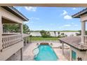 Stunning pool and spa overlooking a lake from a home's balcony at 16716 Artimino Loop, Montverde, FL 34756