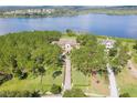 Luxury home on a lakefront property with lush landscaping at 16716 Artimino Loop, Montverde, FL 34756
