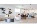 Open floor plan with modern kitchen, dining table, and living room area at 7904 Waterfield Ave # 1, Orlando, FL 32832