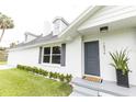 Front entrance of a renovated house with gray door and landscaping at 1836 Se 6Th Ave, Ocala, FL 34471