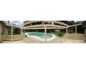 View of a kidney-shaped pool from a covered patio at 225 Se 30Th Ave, Ocala, FL 34471