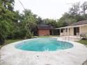 Inviting kidney-shaped pool with a wooden deck perfect for relaxation at 225 Se 30Th Ave, Ocala, FL 34471