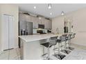 Modern kitchen with gray cabinets, white countertops, and stainless steel appliances at 8984 Stinger Dr, Champions Gate, FL 33896