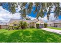 Single-story house with gray garage and basketball hoop at 132 Robbins Rest Cir, Davenport, FL 33896