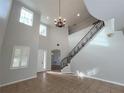 Two-story living room with tile floors and chandelier at 4538 Indian Deer Rd, Windermere, FL 34786