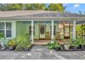 Inviting front porch with rocking chairs and lush landscaping at 191 E Ponkan Rd, Apopka, FL 32712