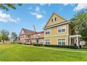 Tan and peach two-story townhomes side by side in a community setting at 2211 San Vittorino Cir # 105, Kissimmee, FL 34741