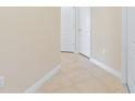 Neutral-toned hallway with tile flooring and access to bedrooms at 8940 Azalea Sands Ln # 8940, Davenport, FL 33896