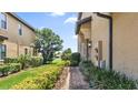 Landscaped side yard with a walkway leading to the home entrance at 8940 Azalea Sands Ln # 8940, Davenport, FL 33896