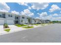 Row of townhouses with garages and lush landscaping at 2609 Bright Jewel St # 2909, Kissimmee, FL 34746