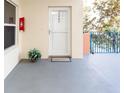 Inviting condo entryway with white door and gray flooring at 5300 S Atlantic Ave # 8-207, New Smyrna Beach, FL 32169