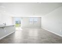 Spacious living area with tile floors and access to the backyard at 1705 Forest Run Ln, Auburndale, FL 33823