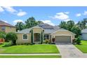 House exterior with lawn and driveway at 2855 Gopherwood Way, Clermont, FL 34711