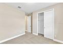 Bright bedroom with neutral walls, carpet, and a large closet at 3116 Legends Preserve Dr, Daytona Beach, FL 32124