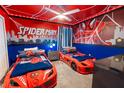 Themed bedroom with Spiderman decor and twin beds at 4546 Narrative Ln, Kissimmee, FL 34746