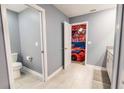 Bathroom with toilet, sink, and access to a Spider-Personal themed bedroom at 4546 Narrative Ln, Kissimmee, FL 34746