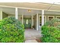 Inviting front porch with green door and lush greenery at 3202 Misty Morn Ct, St Cloud, FL 34771