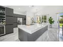 Modern kitchen with a large island and stainless steel appliances at 9226 Longfellow Pl, Apopka, FL 32703