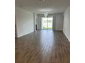 Bright and airy living room with tile floors and access to a lake view at 2927 Camden Way, Davenport, FL 33837