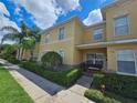 Townhome with yellow exterior, well maintained landscaping, and a welcoming porch at 5434 River Rock Rd, Lakeland, FL 33809