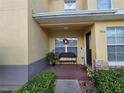 Townhome's front porch with a welcoming bench and decor at 5434 River Rock Rd, Lakeland, FL 33809