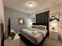 Comfortable bedroom with king-size bed and stylish decor at 8940 Sydney Ave, Kissimmee, FL 34747